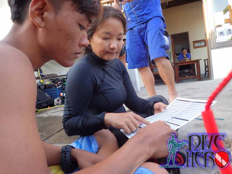 Environmental activists record data on Marine Debris for Project Aware in Bali Indonesia after doing a Dive Against Debris